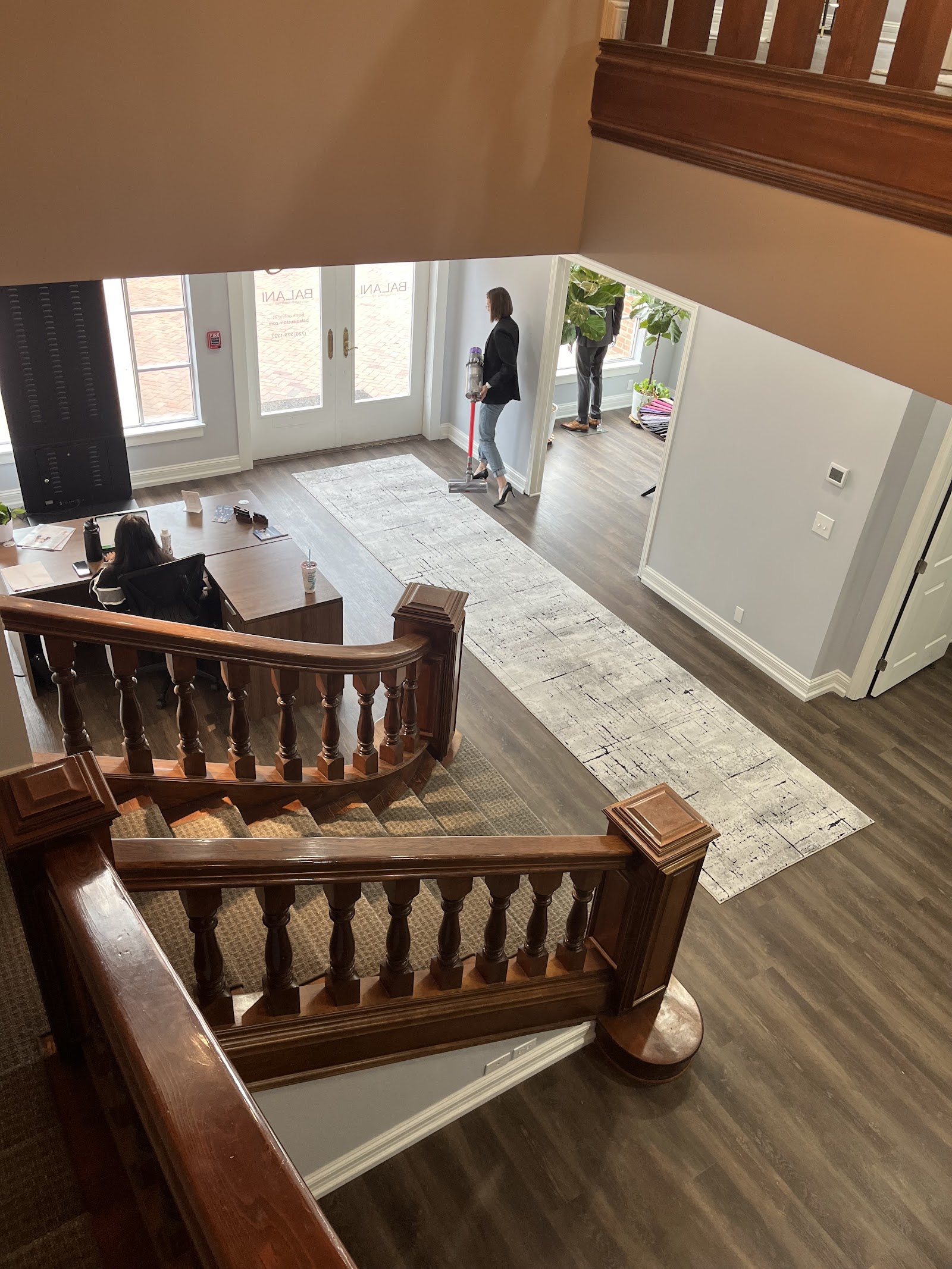 Finished runner rug extending from a stair landing into a hallway.