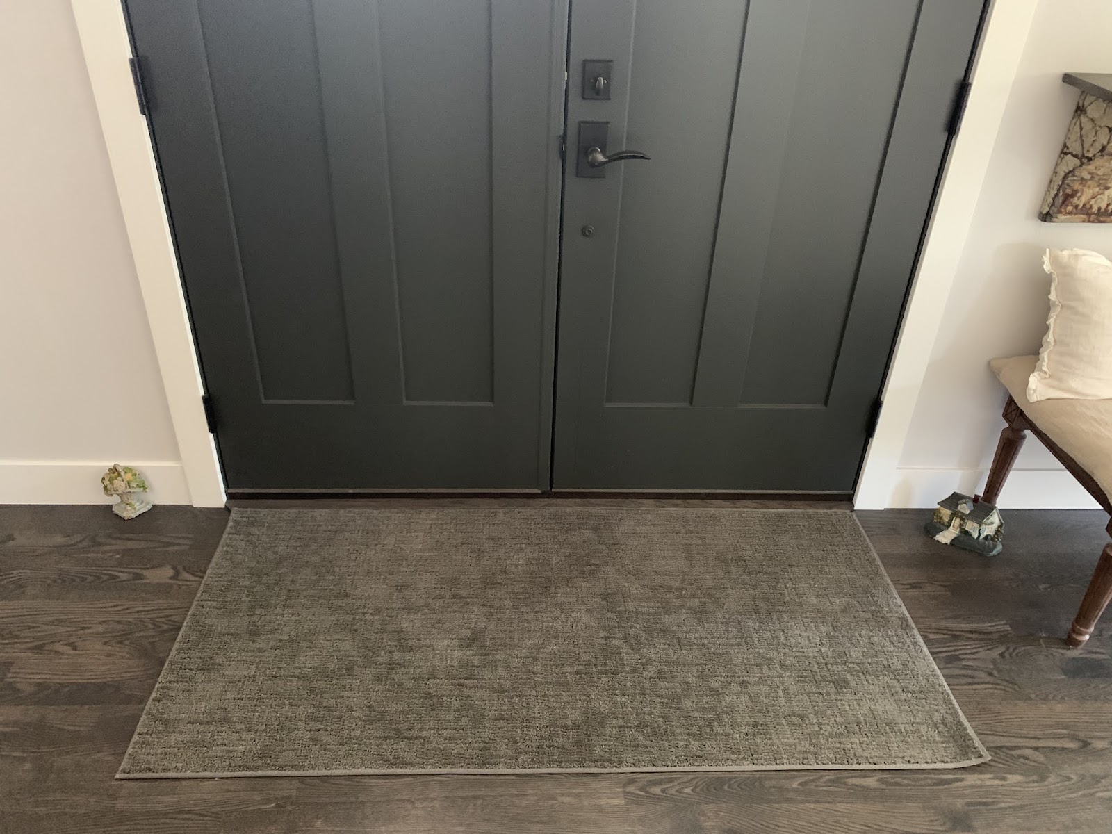 Finished bound rug fitted across a front-door entry in a Denver-area home.